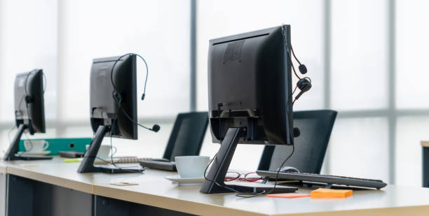 istock Call center computers and headsets all in office 1266675077