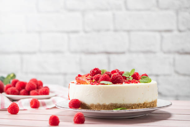 istock Cheesecake with fresh raspberries and plums 1266679772
