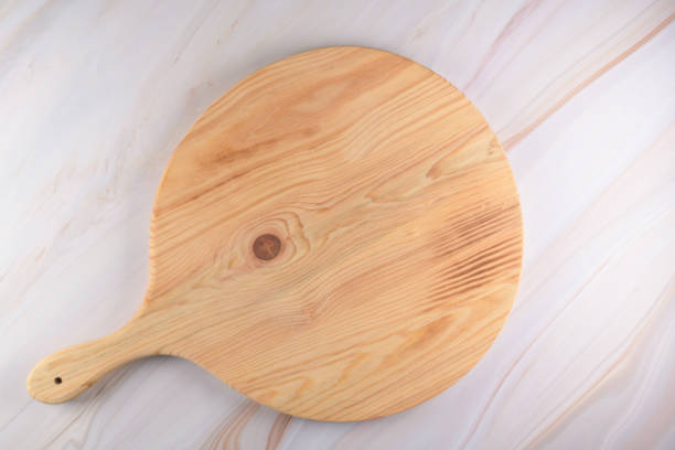 istock Wooden cutting board on a gray marble background 1266682098