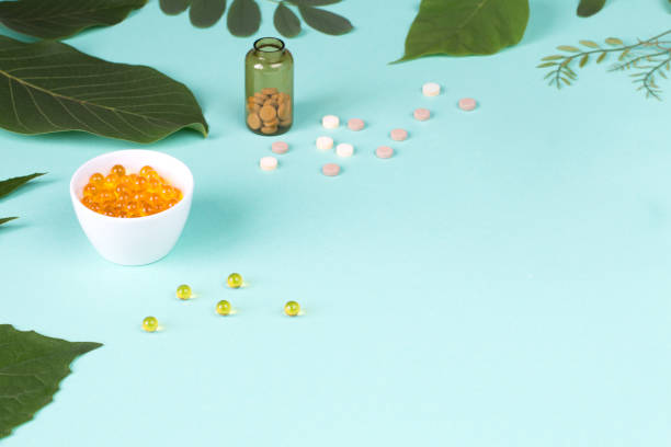 istock Herbal pills on green background 1266685025