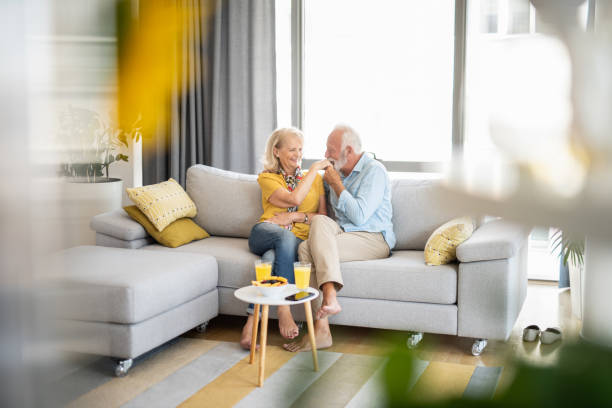 istock Romantic senior couple relaxing at home on sofa. 1266688604
