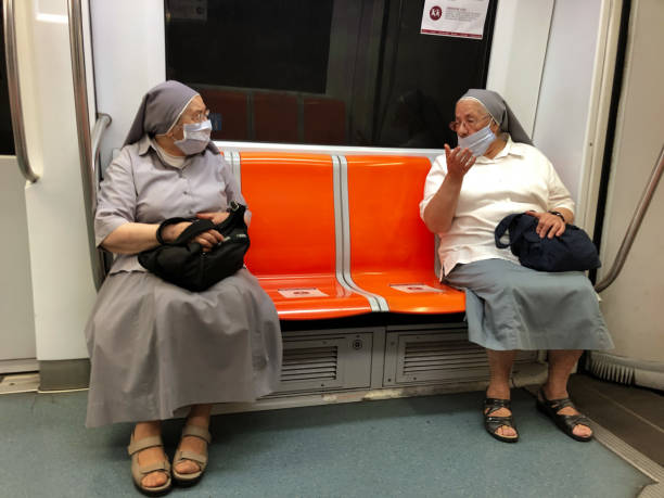 people wearing protective face masks in a pubblic transport during the coronavirus emergency in italy. rome, 07/09/2020 - travel passenger milan italy italy imagens e fotografias de stock