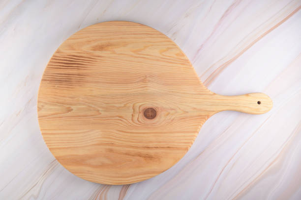 istock Wooden cutting board on a gray marble background 1266692494
