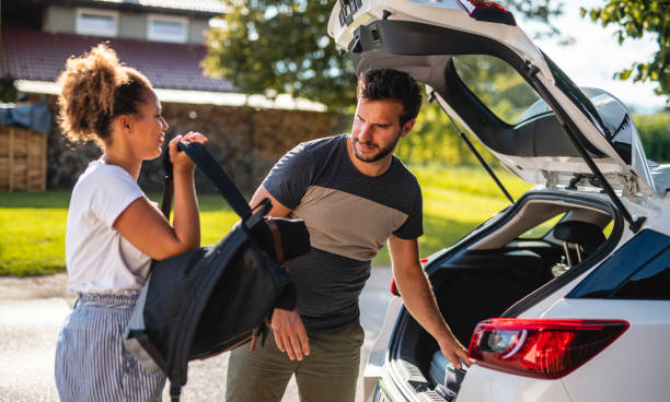 istock Couple packing their bags in a car 1266692685