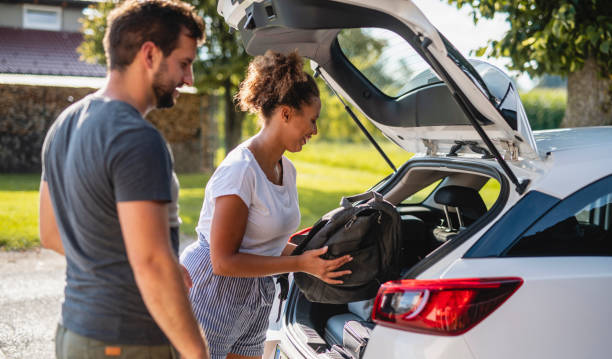istock Couple packing their bags in a car 1266692755