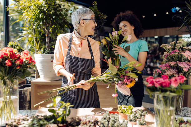 istock Two florist making flower bouquets at their store 1266703035