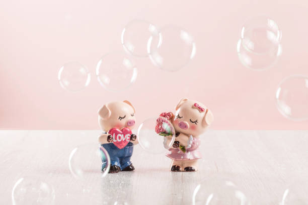 istock Two cute little piggy dolls 1266703202