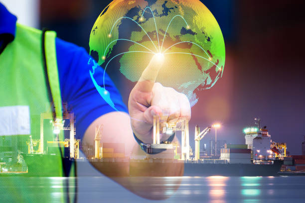 istock Double of engineer point to globe simulation with line connect to country with transportation shipment check for control loading containers box from Cargo freight ship for import and export 1266705087