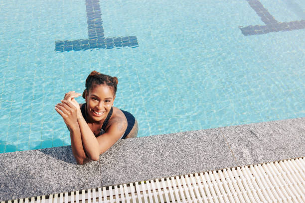 istock Smiling woman in swimming pool 1266705363