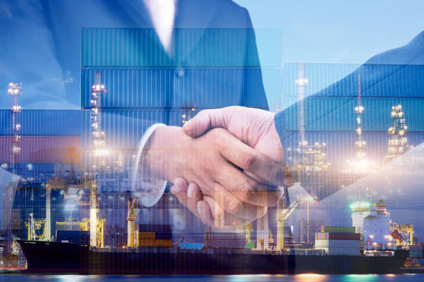 istock Businessman standing cargo at the container yard and greeting each other with handshake for success deal partnership on construction site Cargo freight ship for import and export. Teamwork concept 1266706967
