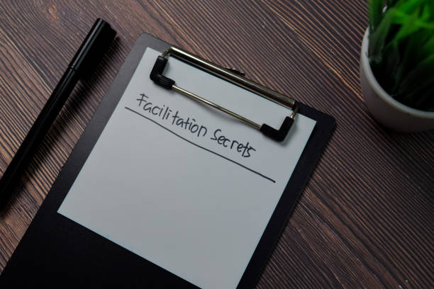 istock Facilitation Secrets write on paperwork isolated on wooden table. 1266708874