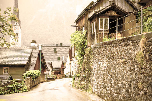 Neo-Gothic Evangelical Church located directly in the centre of Hallstatt in Austria.  Rain, morning mist and clouds over the  Austrian medieval small city. Vintage style