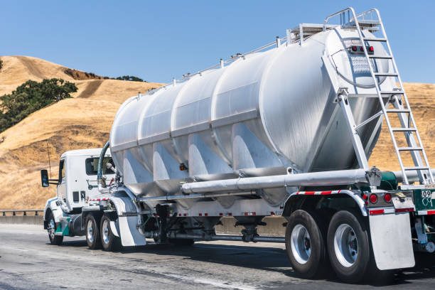 tanker truck driving on the freeway - fuel tanker imagens e fotografias de stock