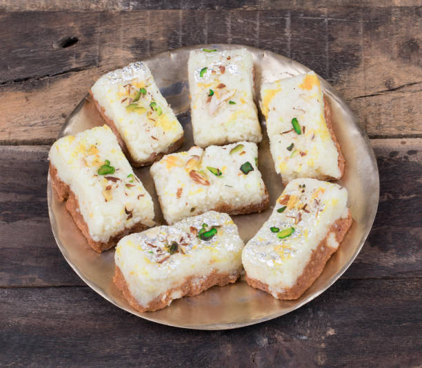 Indian Diwali Sweet Food Kalakand on Wooden Background Indian Diwali Sweet Food Kalakand Also Know as Halwa or Mawa Kalakand is a Creamy Delicacy Made From Paneer or Cottage Cheese, The Dish Originated in Alwar, Rajasthan. Kalakand on Wooden Background mithai stock pictures, royalty-free photos & images