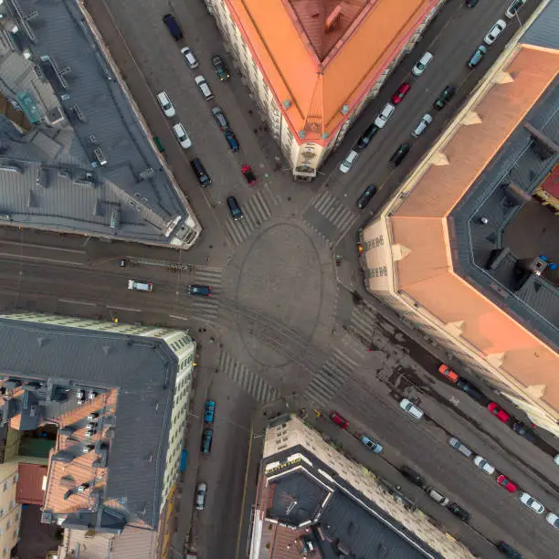 Directly above a five-way intersection with tramline and traffic