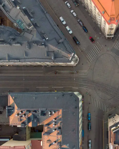 Directly above a five-way intersection with tramline and traffic