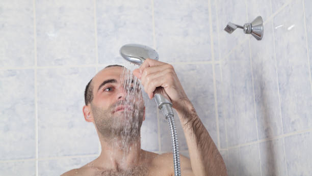 istock Caucasian person in bathroom. Man taking shower 1266717254