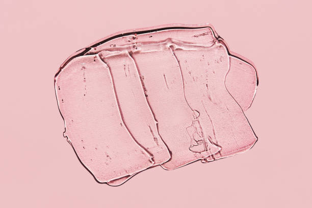 istock Transparent gel spot on pink background. Textured smear with oxygen bubbles 1266719505