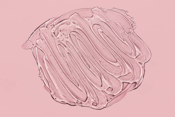 istock Textured smear of gel with oxygen bubbles on pink background 1266719506