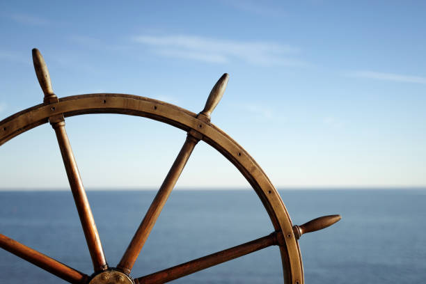 istock Ship wheel and blue sea on background. 1266719522