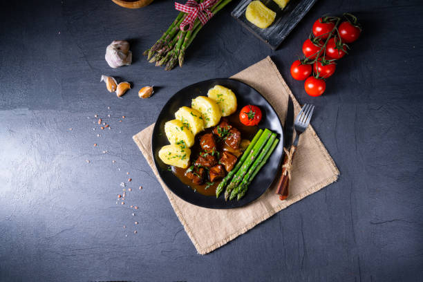 istock dumplings with beef goulash and green asparagus 1266720424