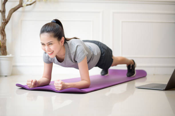 istock fitness woman exercise in home 1266725103