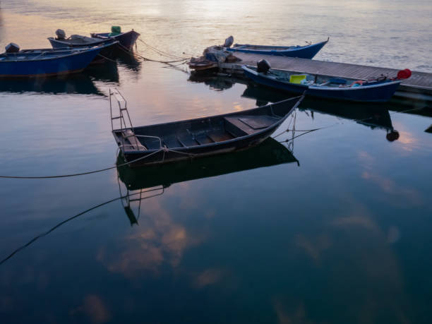 istock Fishing boats moored in a small pier 1266725110