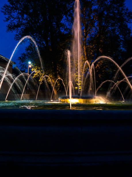 istock Fountain with water jets and lights at night 1266725404