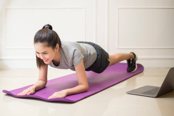 istock fitness woman exercise in home 1266725443