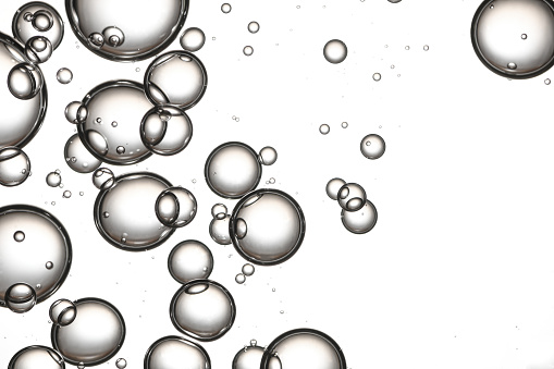Silver colored water bubbles isolated over a white background