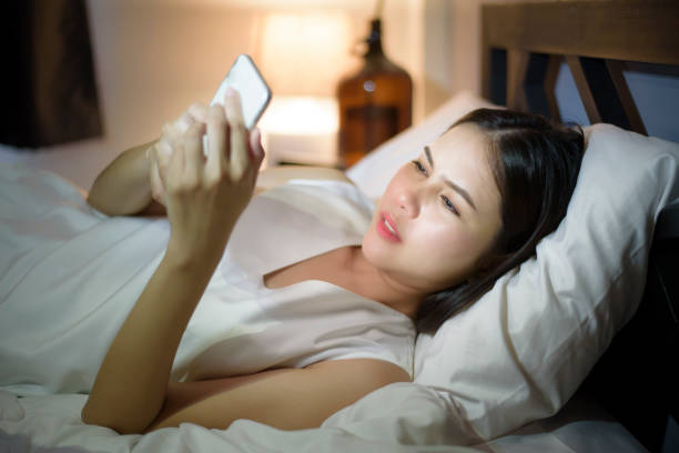 istock Woman is feeling eye pain when using smart phone at night 1266727443