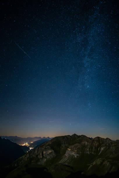 istock night sky over mountain village 1266727980