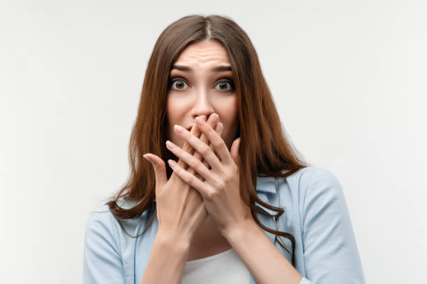 istock Scared caucasian girl covering mouth with hands. Keep silence concept. 1266729008