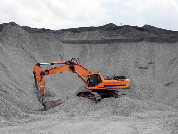 Red excavator in the quarry for loading aggregates. Pause in the work of a crawler excavator in a quarry on the extraction of soil.