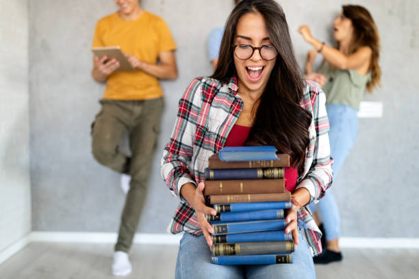 istock People, knowledge, education and school concept. Happy student girl with book 1266729183