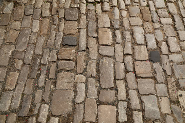 istock Abstract background of old cobblestone pavement close-up 1266730330