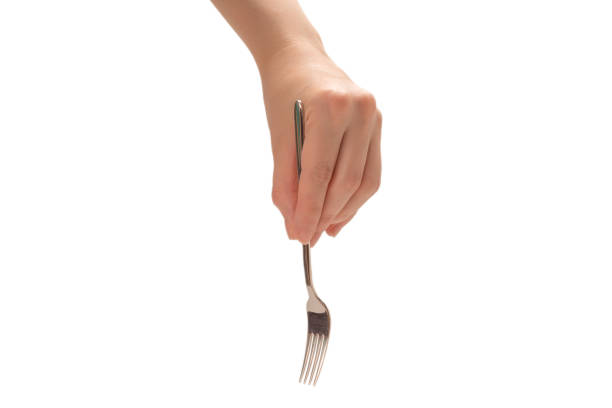 istock Fork in woman hand isolated on white. 1266731917