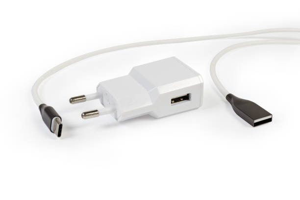 istock Mobile devices charger and appropriate cable on a white background 1266734837