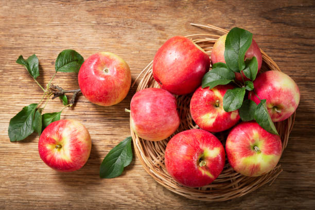 istock fresh apples on a wooden table 1266735707