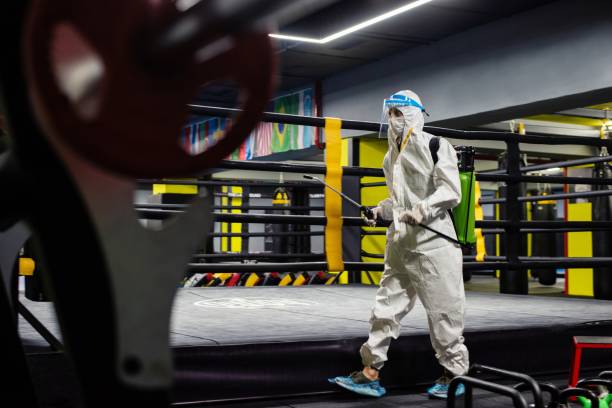 istock Gym employee wearing PPE and disinfecting everything 1266735924