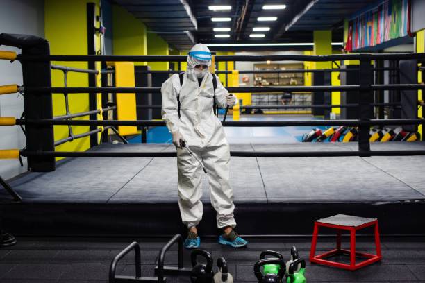 istock Gym employee wearing PPE and disinfecting everything 1266735925