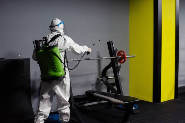 istock Gym employee wearing PPE and disinfecting everything 1266735931