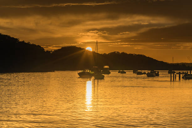 istock Sunrays and clouds - Golden Sunrise over the Bay 1266736051