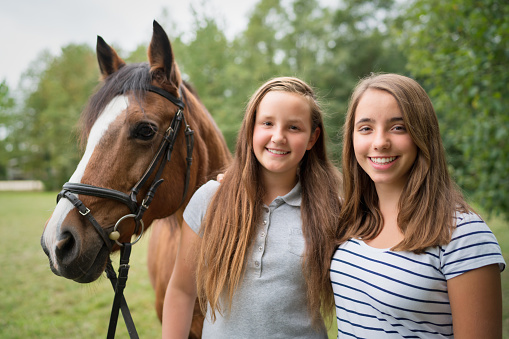 Portrait, horse and woman with pet at ranch, bonding and animal care in the countryside outdoors. Pets, equestrian and horseback rider or smile of happy female with white stallion on farm outside.