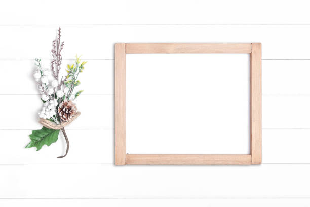 istock Horizontal wooden frame and branches on white wooden background 1266739555
