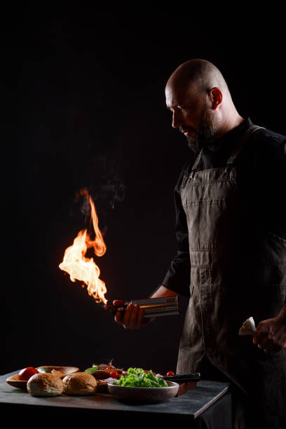 istock Cef cooks burgers, roasts meatballs on open fire. 1266740954
