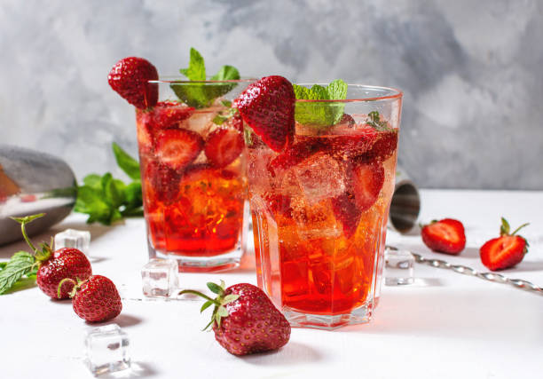istock Strawberry mojito and ingredients on white wooden background 1266741393