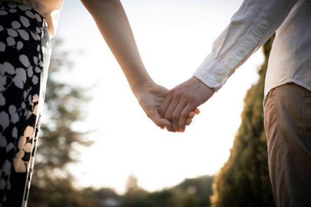 istock Love hands. Couple's hands. Lovers outside on the sunset 1266742155