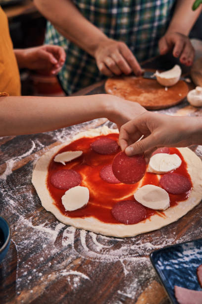 istock Kids Baking Pizza at Home in Domestic Kitchen 1266742193