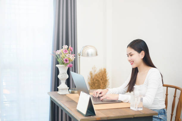 istock Beautiful woman is working from home 1266743510